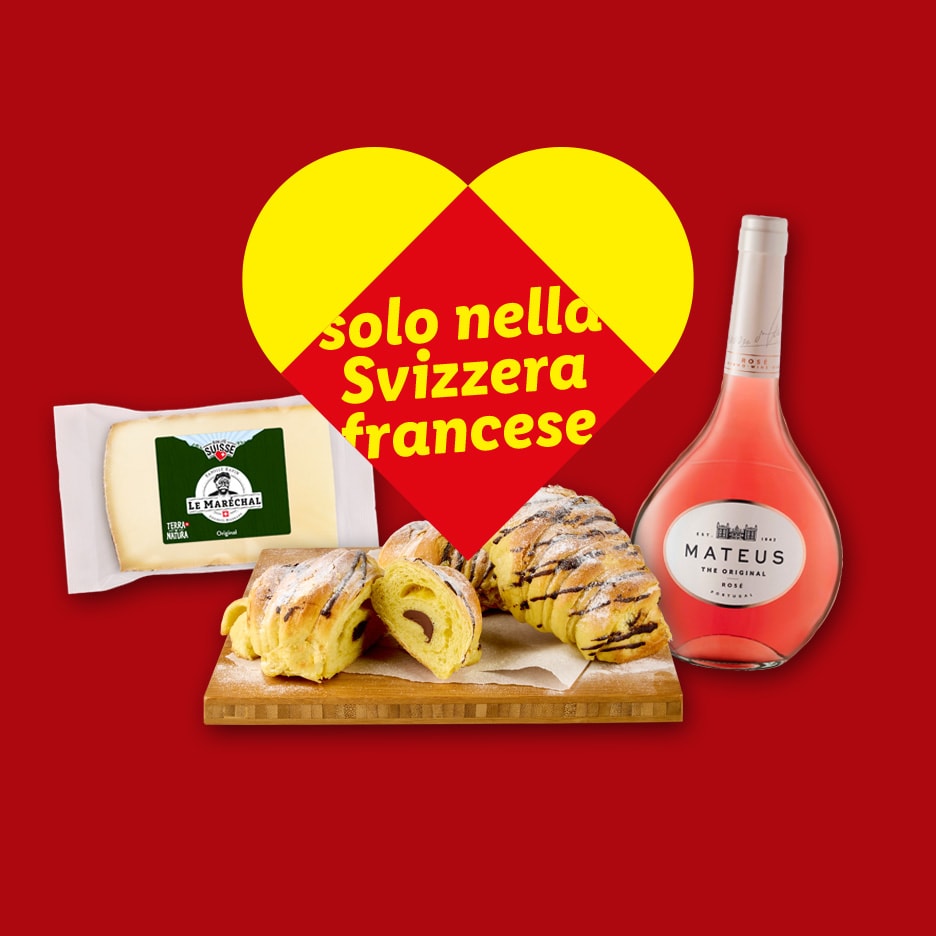 Käse, Schokoladenbrötchen und eine Flasche Mateus Rosé vor einem roten Hintergrund mit einem gelb-roten Herz.
