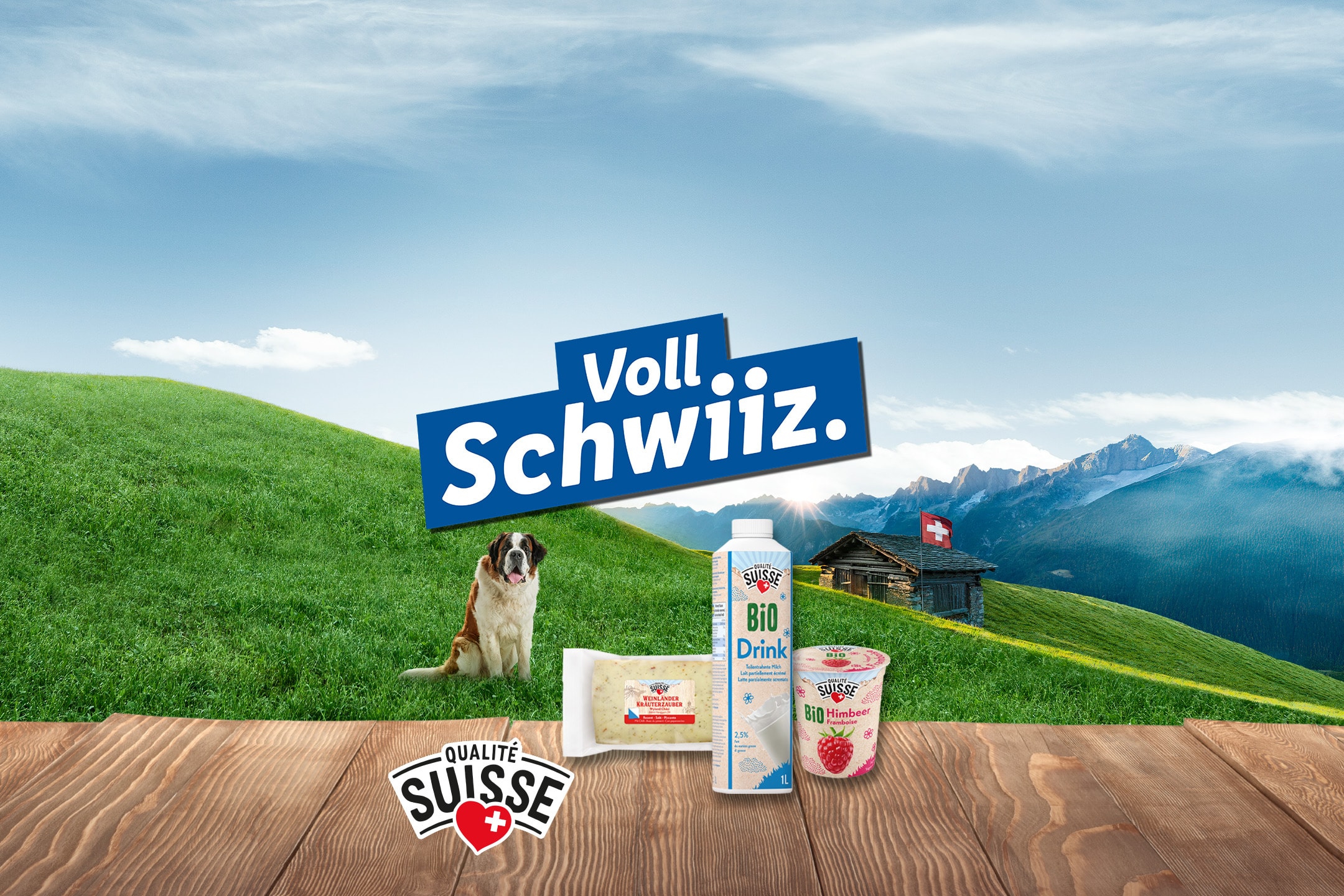 Schweizer Getränke und Milchprodukte auf einem Holztisch mit Hund und Bergen.