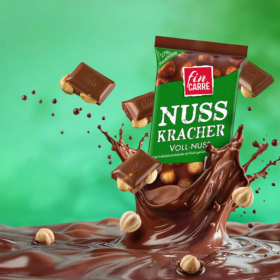 Vollmilchschokolade mit Haselnüssen, mit Schokoladenstücken und Haselnüssen, die in geschmolzene Schokolade fallen.