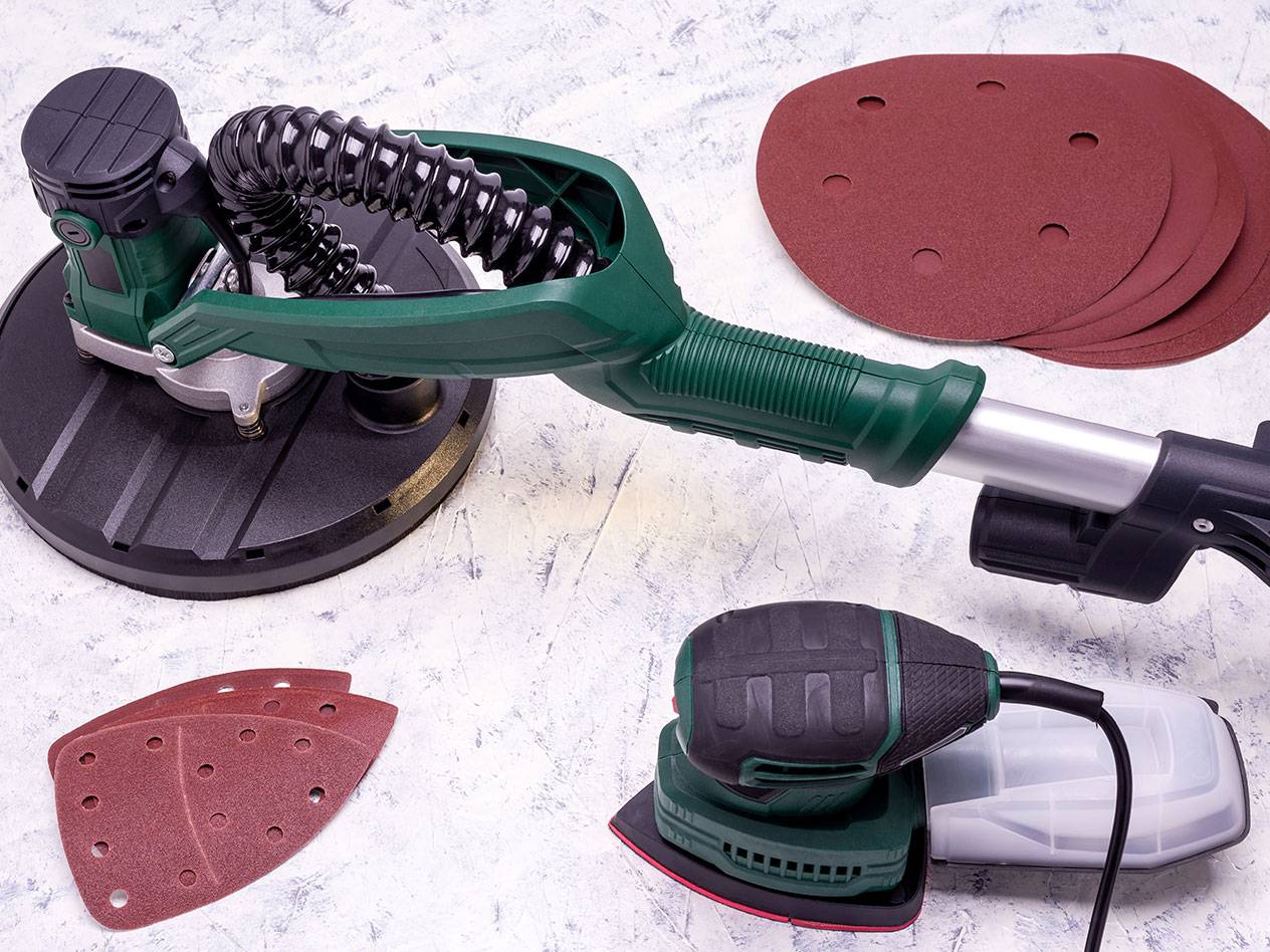 Levigatrici elettriche con accessori per levigatura su sfondo chiaro.