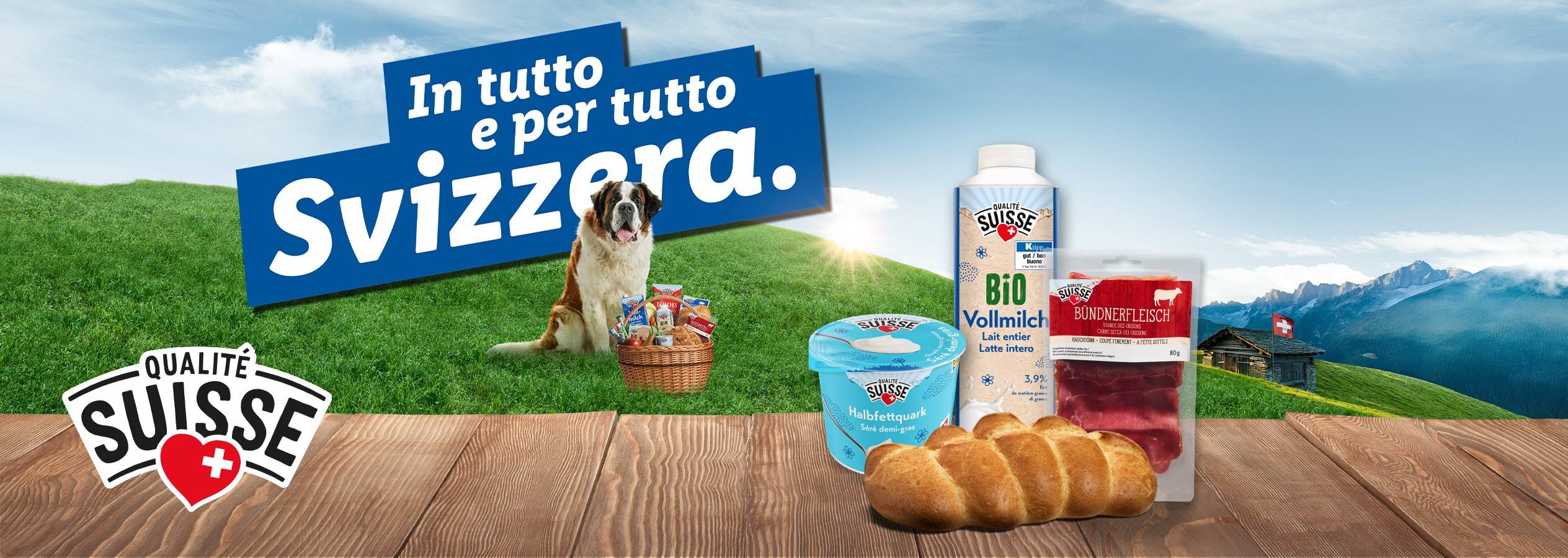 Prodotti Qualité Suisse come latte, quark e bresaola con un San Bernardo e un paesaggio montano svizzero.