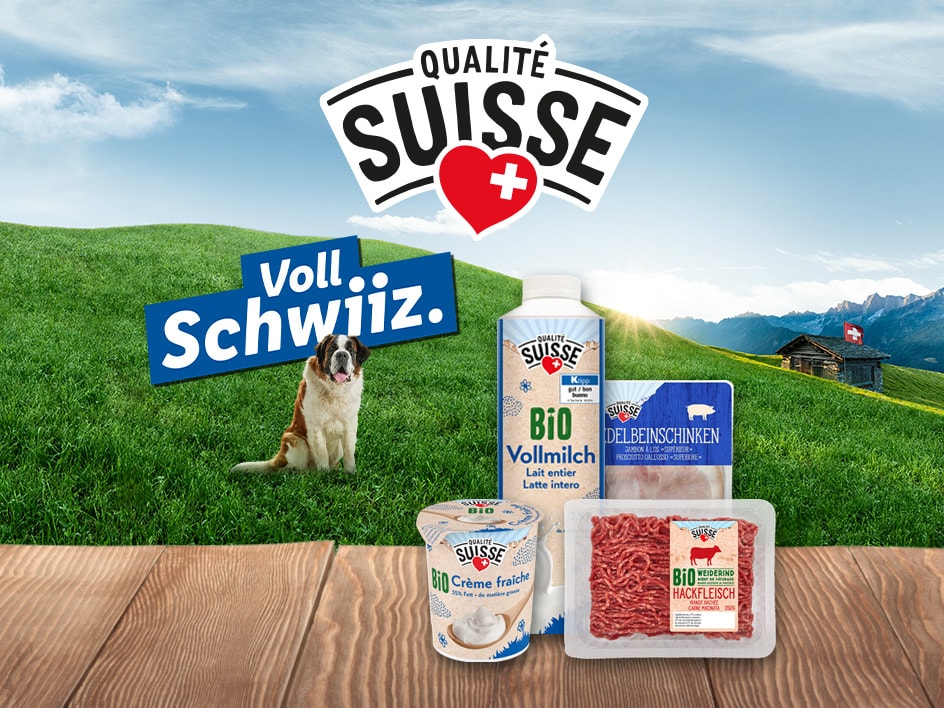 Schweizer Milchprodukte und Fleisch mit einem Bernhardiner und einer Berglandschaft.