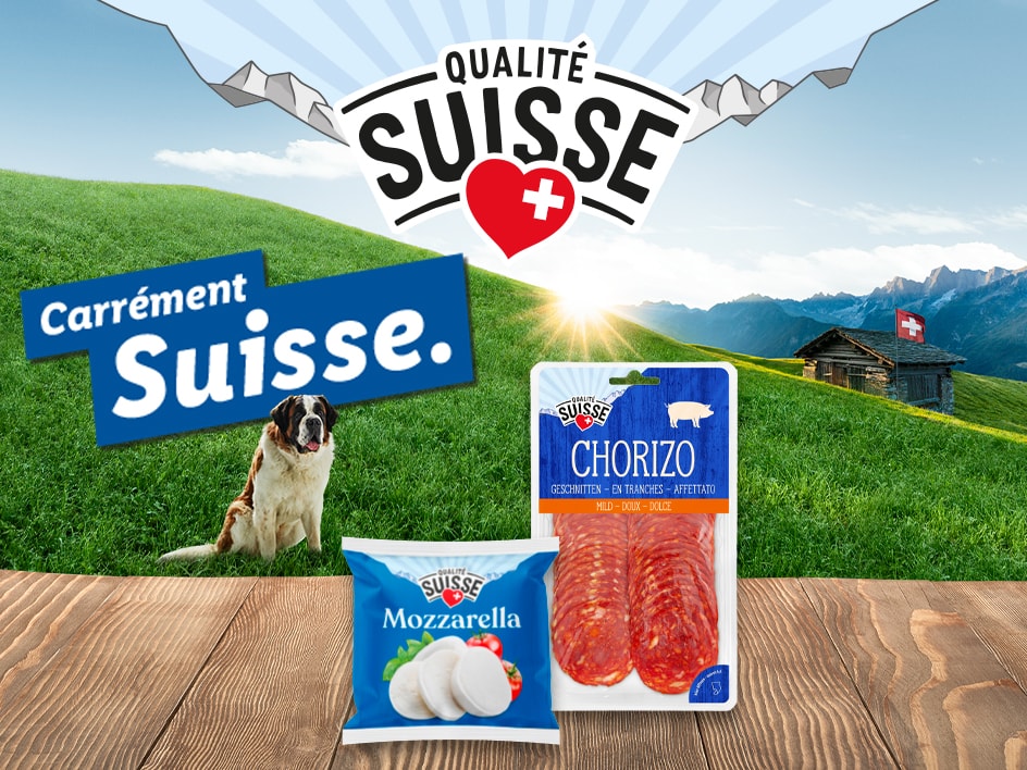 Qualité Suisse présente du chorizo et de la mozzarella, avec un Saint-Bernard dans un paysage suisse idyllique.