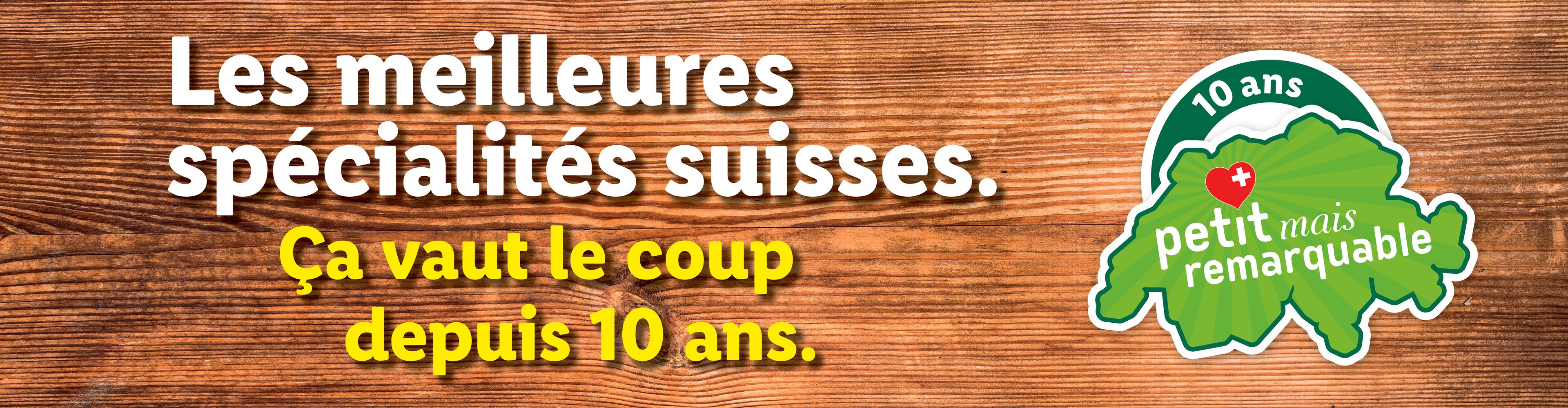 Spécialités suisses sur fond de bois, avec logo '10 ans petit mais remarquable'.