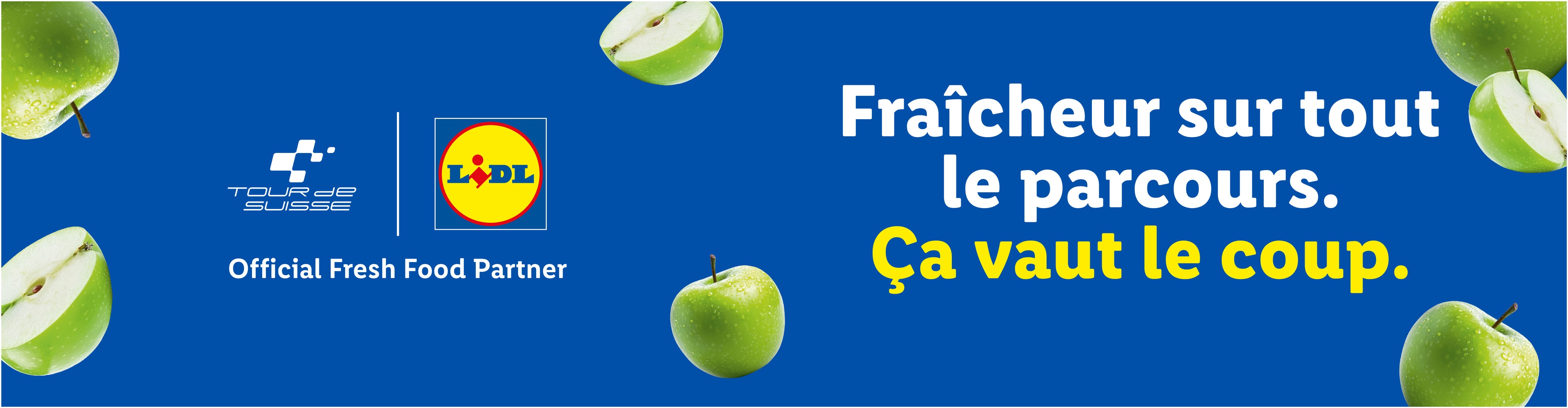 Pommes vertes fraîches sur fond bleu avec le texte 'Fraîcheur sur tout le parcours. Ça vaut le coup.'