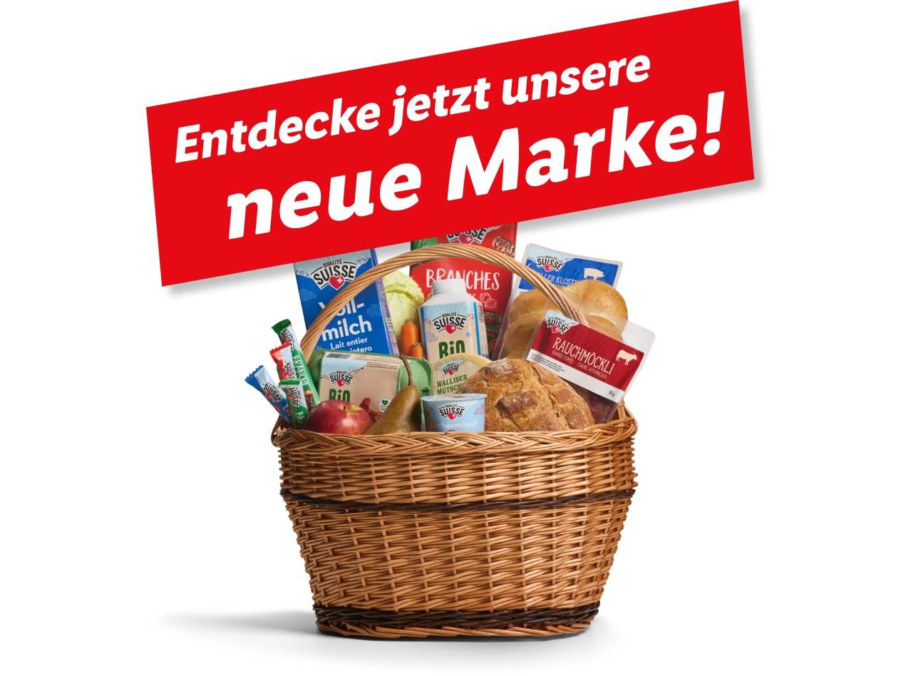 Ein Korb mit Suissesse-Produkten, darunter Milch, Brot und Snacks, kündigt eine neue Marke an.