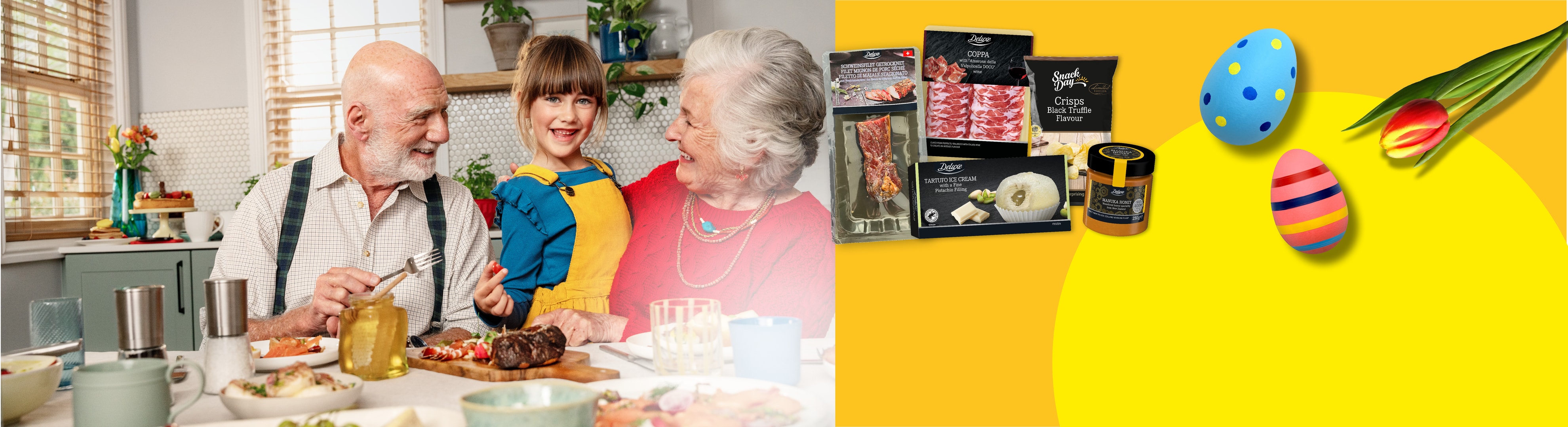 Familie am Tisch mit Deluxe-Produkten, Ostereiern und einer Tulpe.