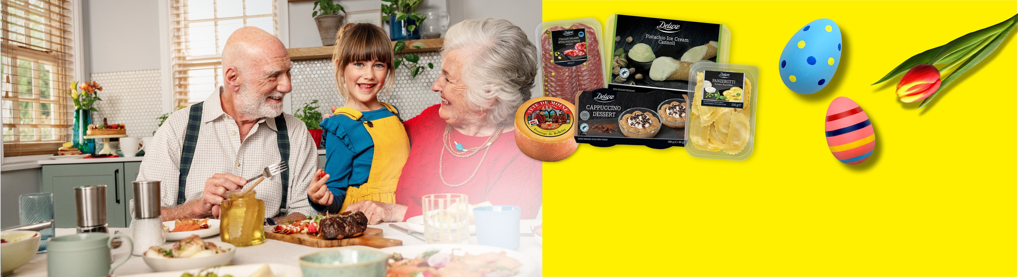 Famiglia a tavola con salumi, formaggio, dessert e pasta, con uova di Pasqua e tulipano.