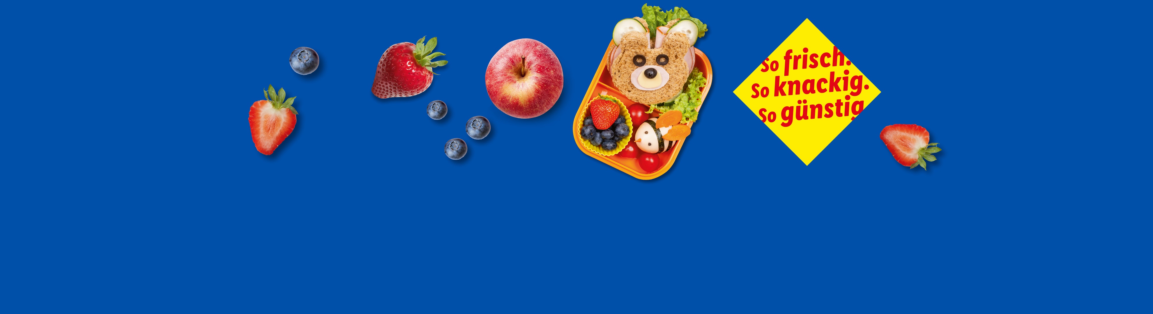 Ein Kinder-Lunchpaket mit einem Bärensandwich, Obst und einer Käsebiene.