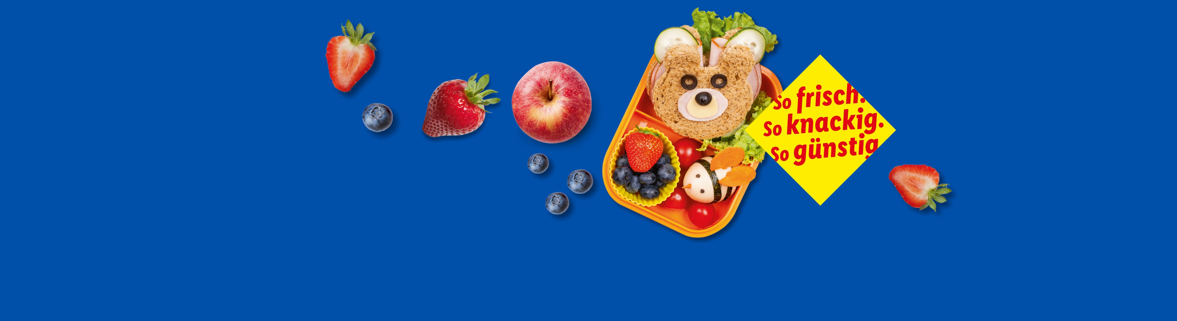 Ein Bären-Lunchpaket mit Obst und einer Werbebotschaft.