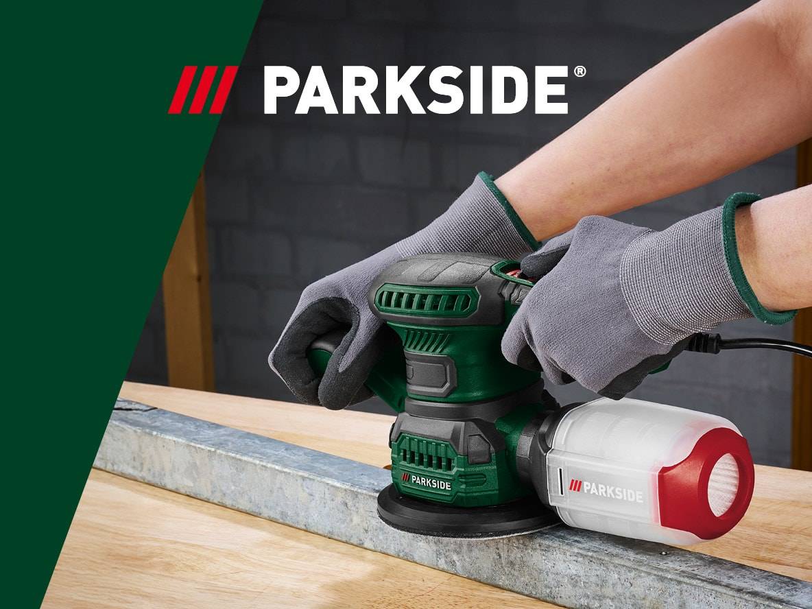 Eine Person verwendet eine Parkside-Schleifmaschine, um ein Metallstück zu schleifen.