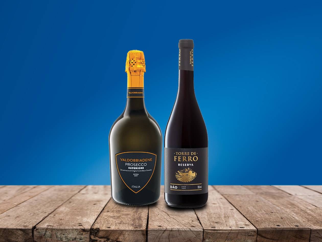 Zwei Weinflaschen, Valdobbiadene Prosecco und Torre de Ferro Reserva, auf Holztisch.